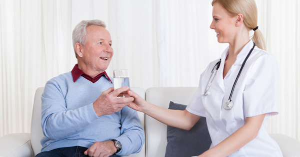 doctor handing glass to patient