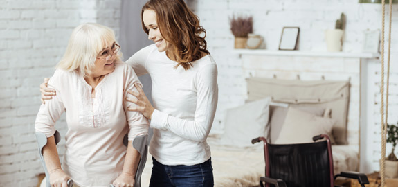 nurse helping disabled senior woman