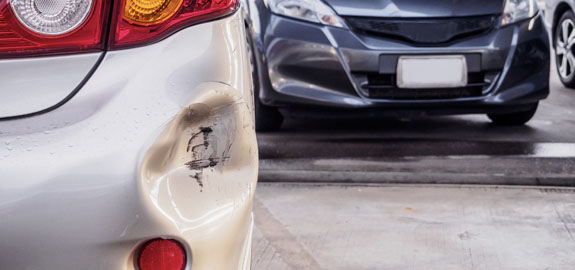 Parked car with a dent