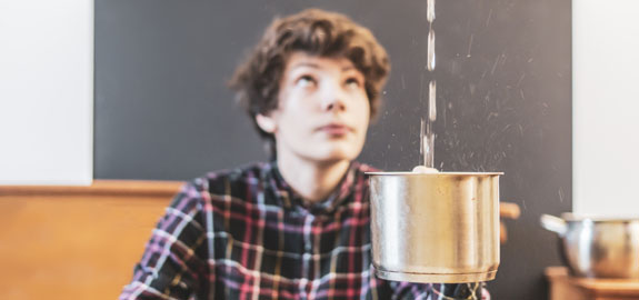 Man holding pot under leak