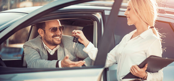 Woman handing rental car keys