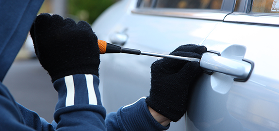 Thief breaking into car