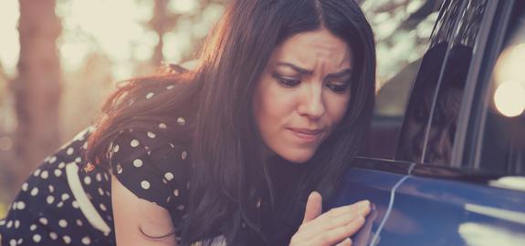 Car owner observing damage